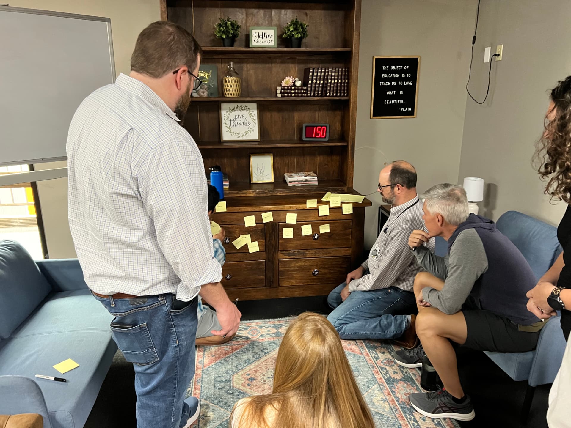 Leaders working through roles and decisions in a facilitated team session.